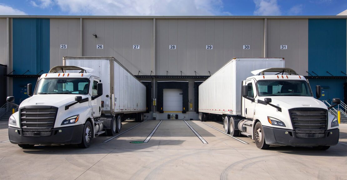 Two tractor trailers at loading docks