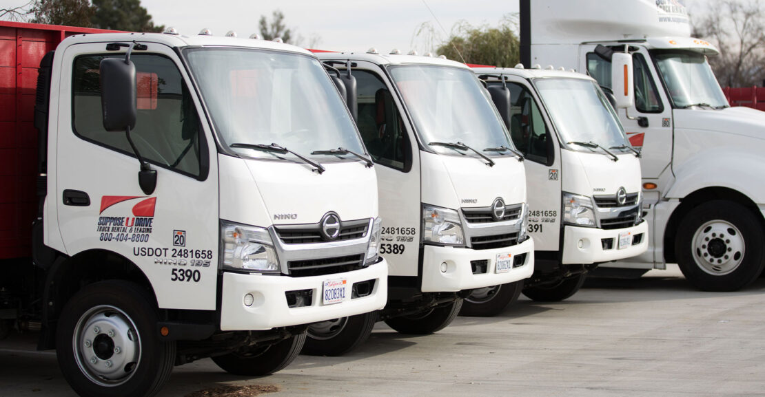 Row of white box trucks