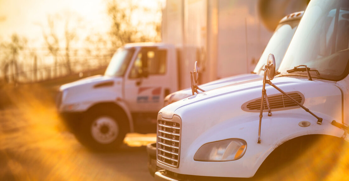 Row of box trucks in the Phoenix sun
