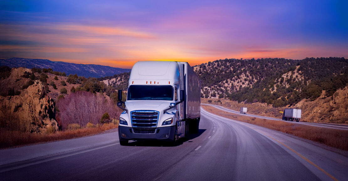 White semi truck on highway in the southwest USA