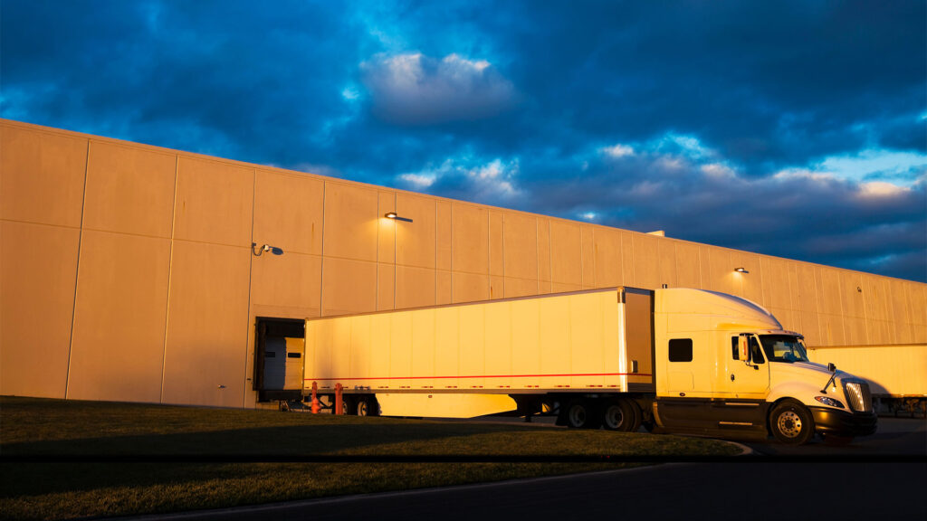 Semi tractor trailer sitting at loading dock.